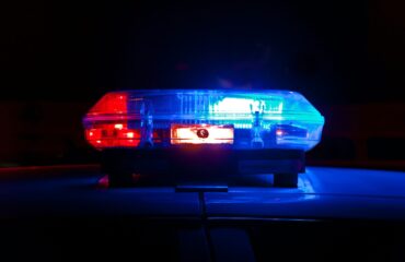 Red and blue police lights on top of police car.