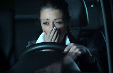 Drowsy woman behind the wheel of a car.