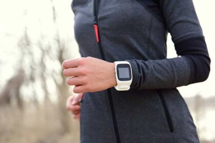 Female jogger with Fitbit device Female jogger with Fitbit device