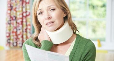 Woman with neck pain injury after car accident.