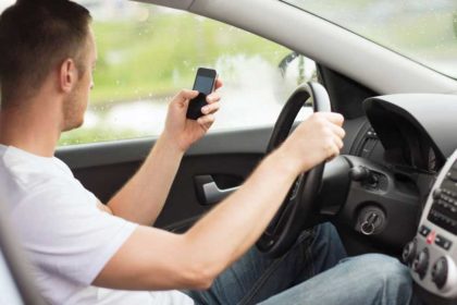 Distracted man using cell phone while driving. Distracted man using cell phone while driving.
