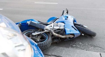 Motorcycle and Car Accident in Roadway