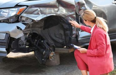 Kansas Car Wreck Settlement Adjuster Inspecting Vehicle