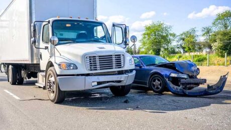Semi-truck and car collide on highway