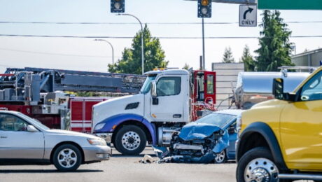 Semi-truck and Car collide in busy intersection. Semi-truck and Car collide in busy intersection.