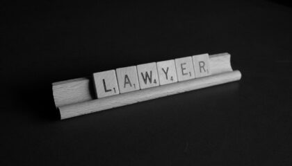 Wooden game tiles with the letters that spell Lawyer.