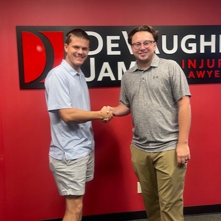 Kansas personal injury attorney Tristan Johnson with client P.H.
